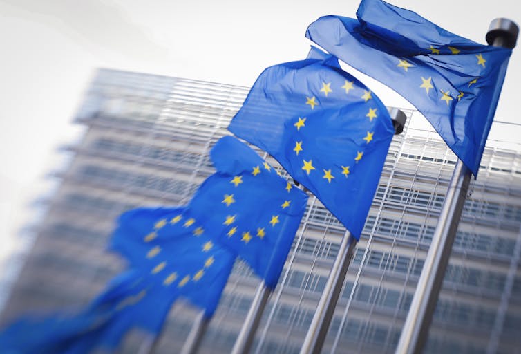 Eu flags with building in background