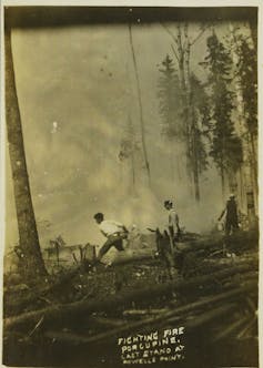 Historic photograph of men fighting fire with buckets