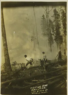 Historic photograph of men fighting fire with buckets