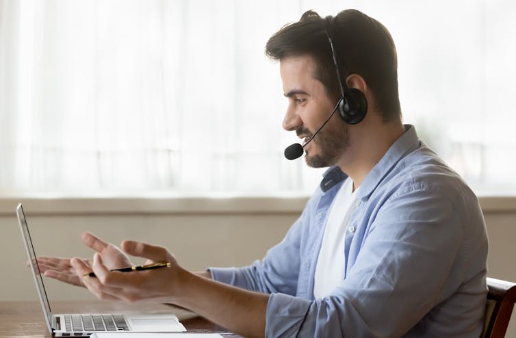 A social worker speaking to someone over a video call.