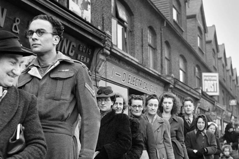 Shoppers in a queue outside in the 1940s
