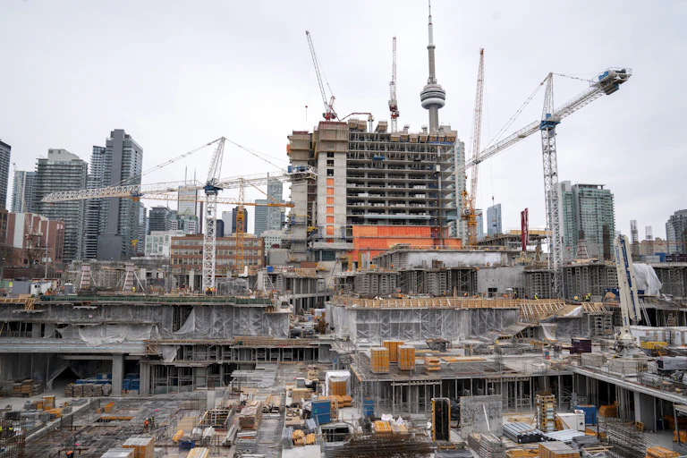 Toronto skyline under construction, several cranes seen with the CN tower in the background