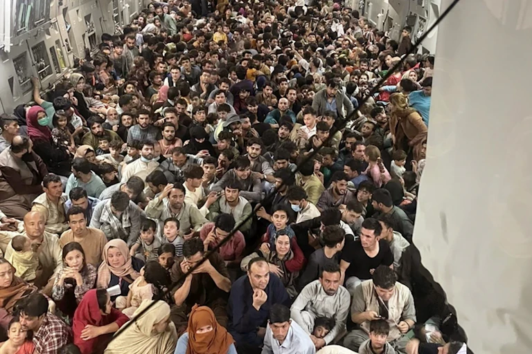 Afghan citizens, inside a U.S. Air Force transport, await takeoff from Karzai Airport.