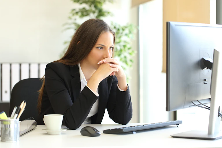 concerned woman reading a computer screen