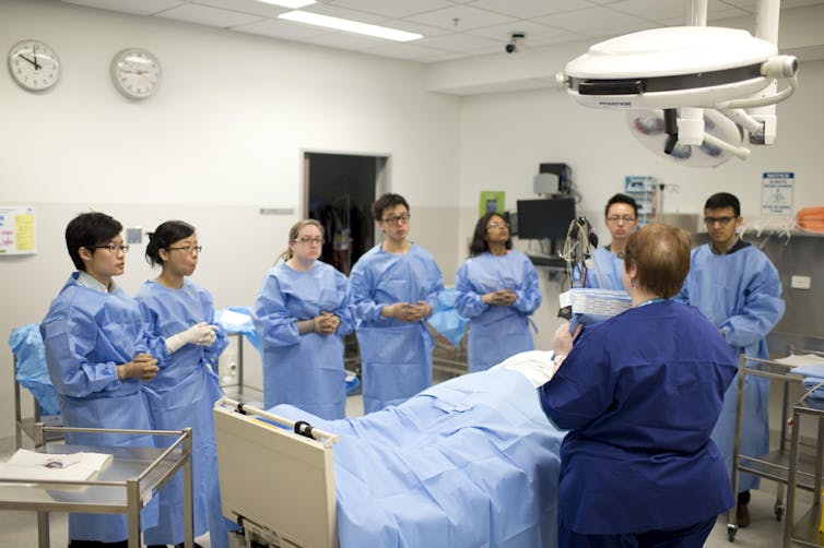 medical students observe surgery in a hospital