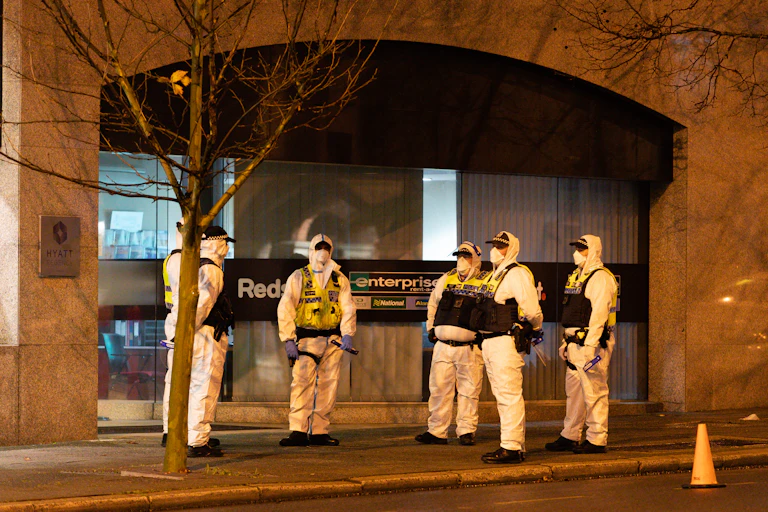 Police officers in protective equipment waiting for Afghan refugee arrivals