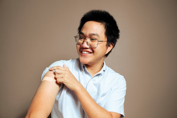 Young person with bandaid on arm after getting vaccinated