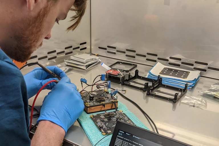 Fergus Downey working on Binar-1 circuit board