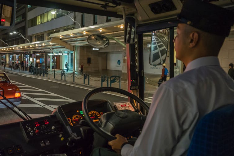 Male transit driver at night