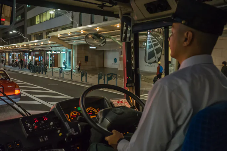 Male transit driver at night