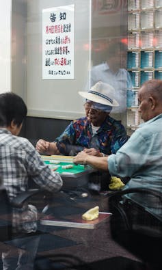 Men gambling in a cafe