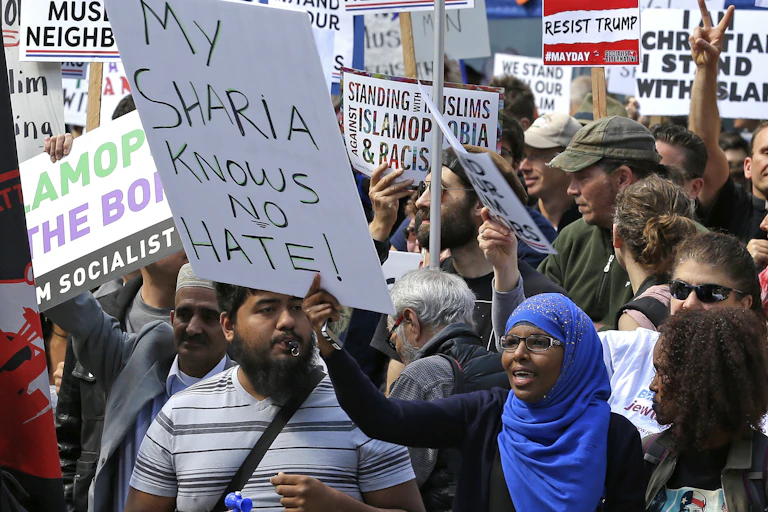 People protesting behind a barrier