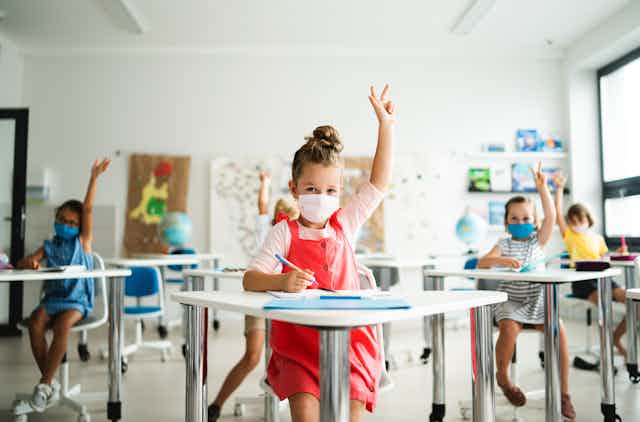 Children with facemasks in classroom
