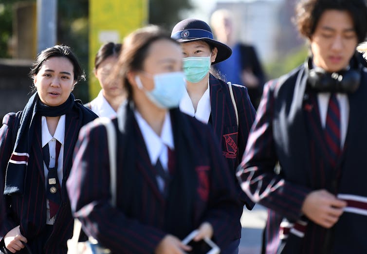 Masked school students in uniform