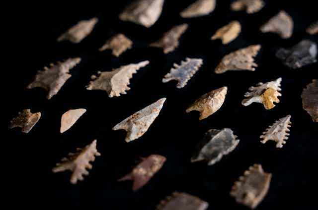 Stone arrowheads (Maros points) and other flaked stone implements from the Toalean culture of South Sulawesi.