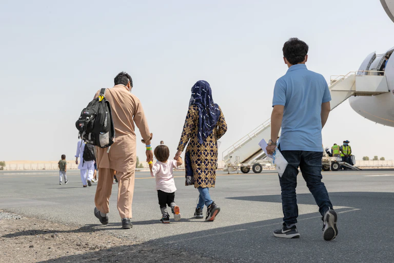 Afghan refugees board a plane for Australia.