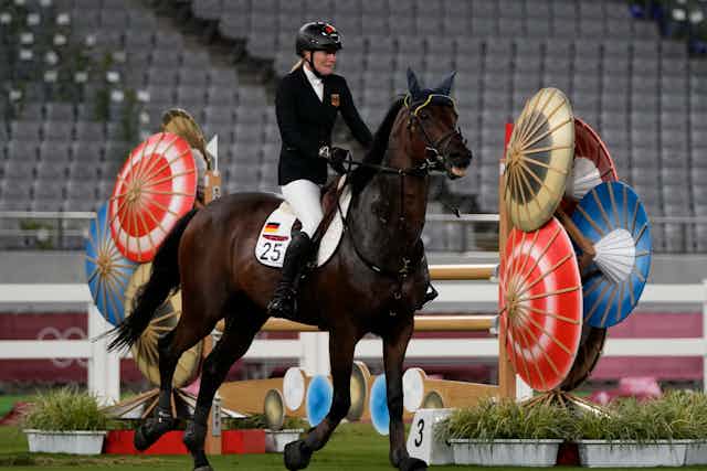 a woman riding a horse in competition