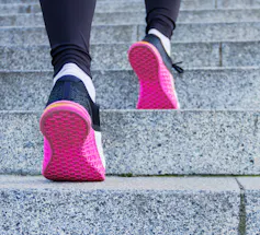 Sneakers walking up outdoor stairs.