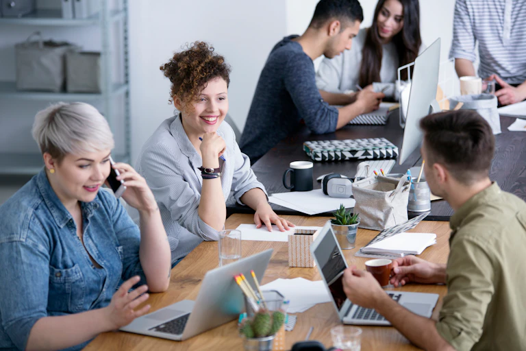 University students discussing a work project around a table