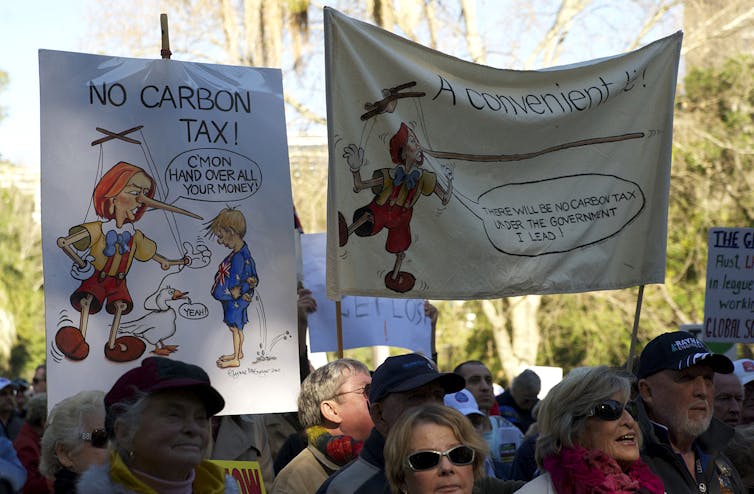 people on crowd hold signs