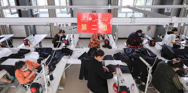 Uyghur people work at a sewing factory in Kashgar, Xinjiang,  May 2021