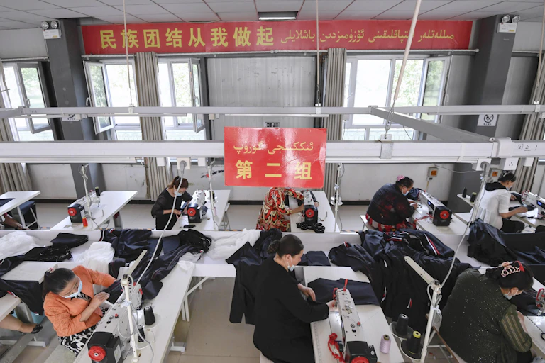 Uyghur people work at a sewing factory in Kashgar, Xinjiang, May 2021
