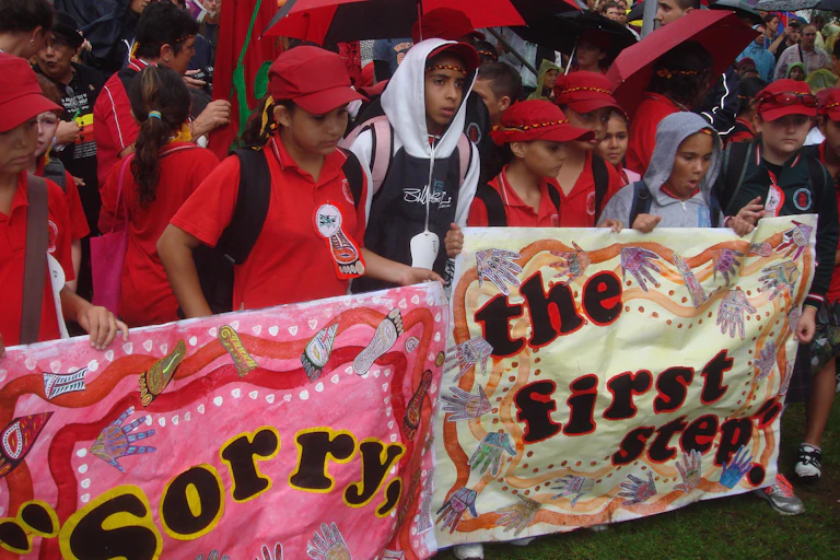 Children display banners at the Redfern Community Centre after watching the live telecast of the formal Apology to the Stolen Generations.