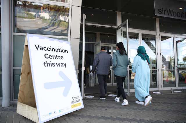 people entering a vaccination centre