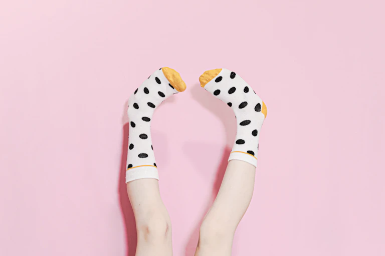 feet in polka dot socks pointing upwards