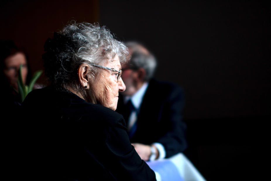 Old woman looking isolated in a public place