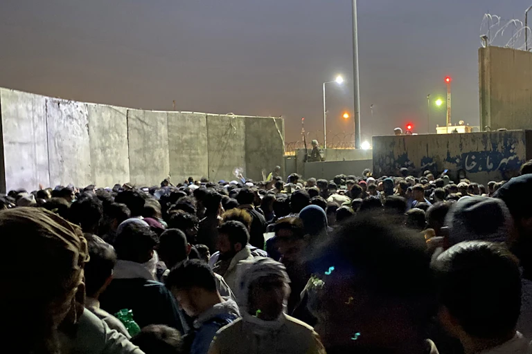 People struggle to get into the Hamid Karzai International Airport