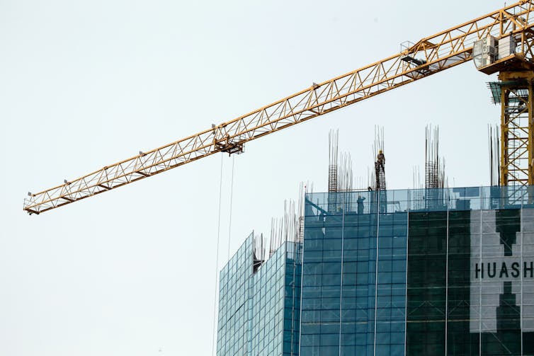 Picture of a crane outside a high-rise building under construction in Shenzhen, Guangdong Province.