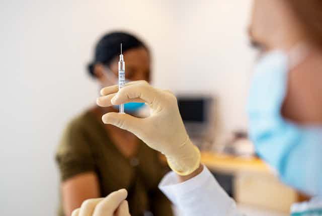 Doctor preparing flu or coronavirus injection