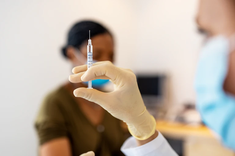 Doctor preparing flu or coronavirus injection