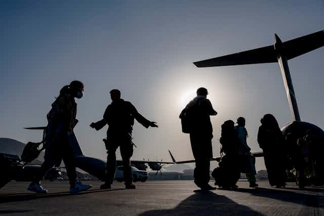silhouetted soldiers and plane