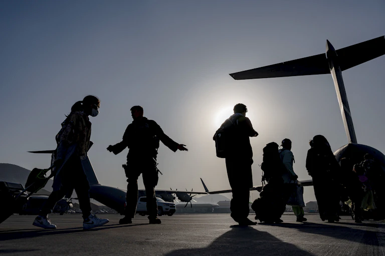silhouetted soldiers and plane
