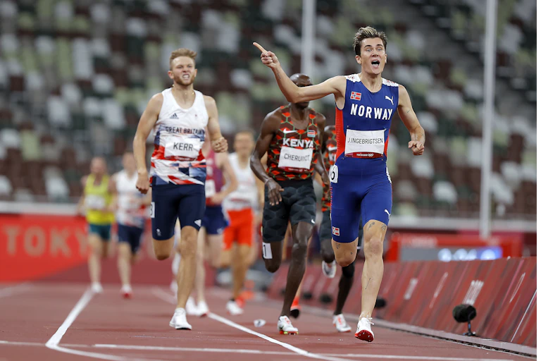 Jakob Ingebrigtsen of Norway crossing the finish line in first place at the Tokyo 2020 Olympics.