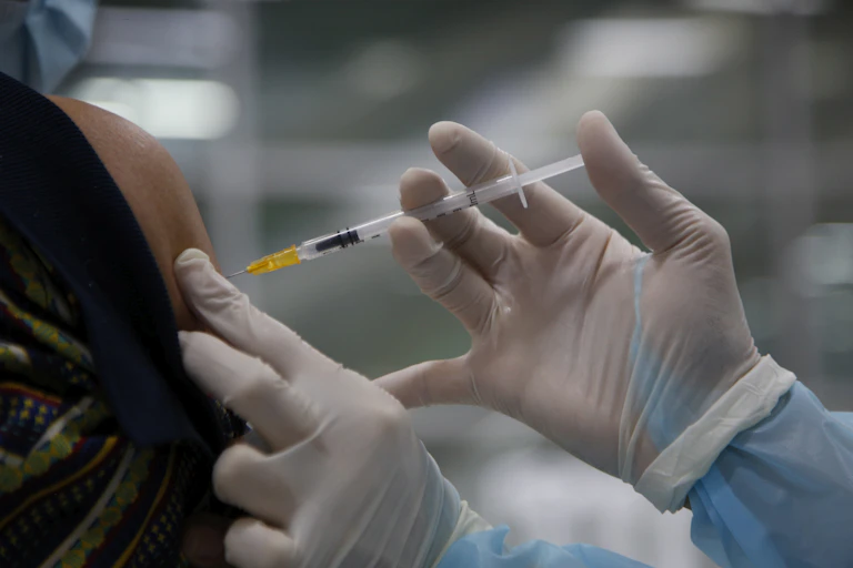 A person receiving a COVID-19 vaccine