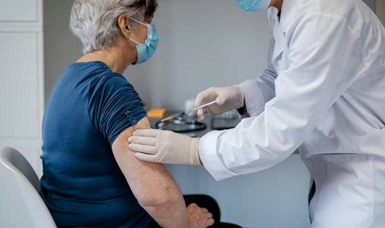 A woman being vaccinated against COVID-19