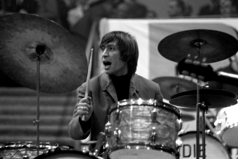 Drummer behind a kit.