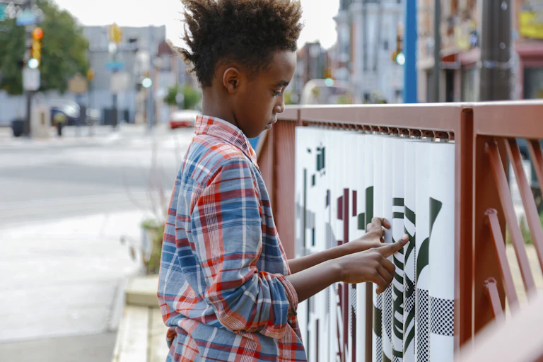 Boy arranges pieces of a spinning wall puzzle