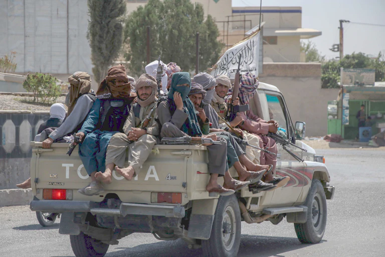 Taliban sit on back of pickup truck in Kandahar.
