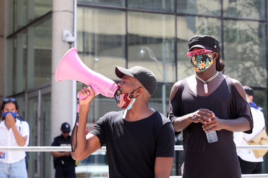 A protestor is seen with a megaphone.