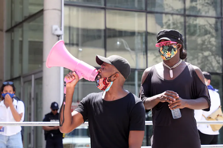 A protestor is seen with a megaphone.