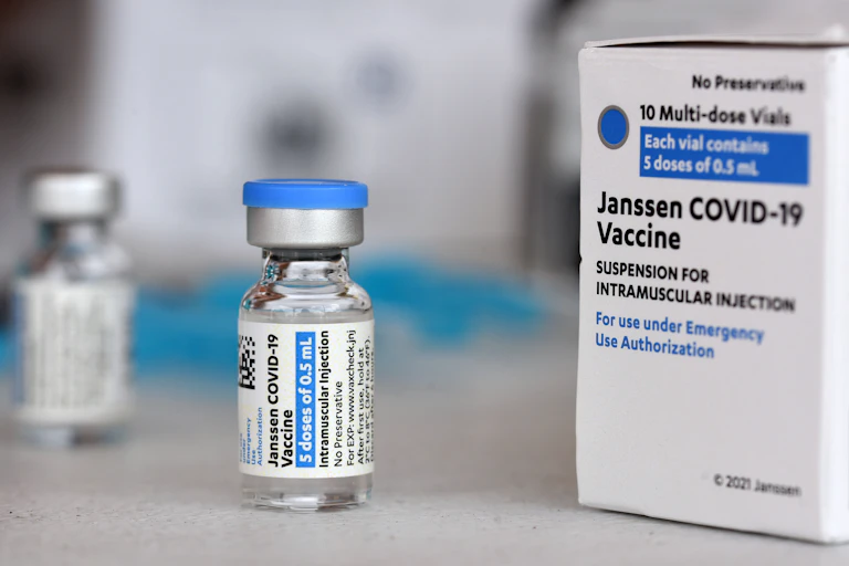 A vaccine vial next to a vaccine box.