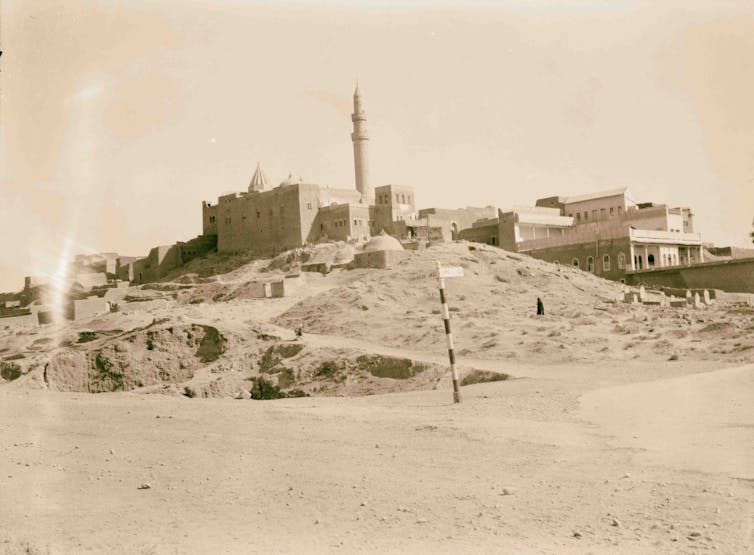 Black-and-white picture of an ancient building with a tower