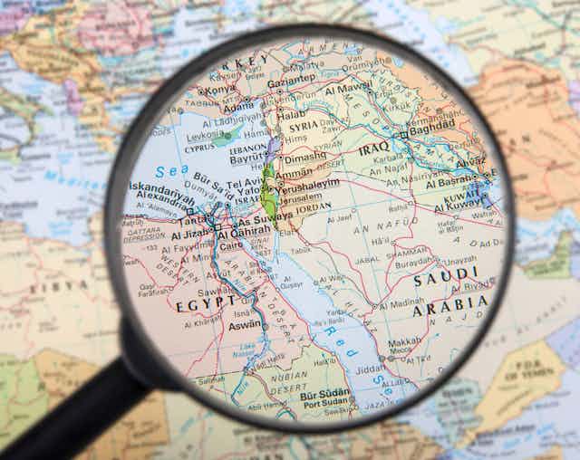 A map of the Middle East under a magnifying glass..