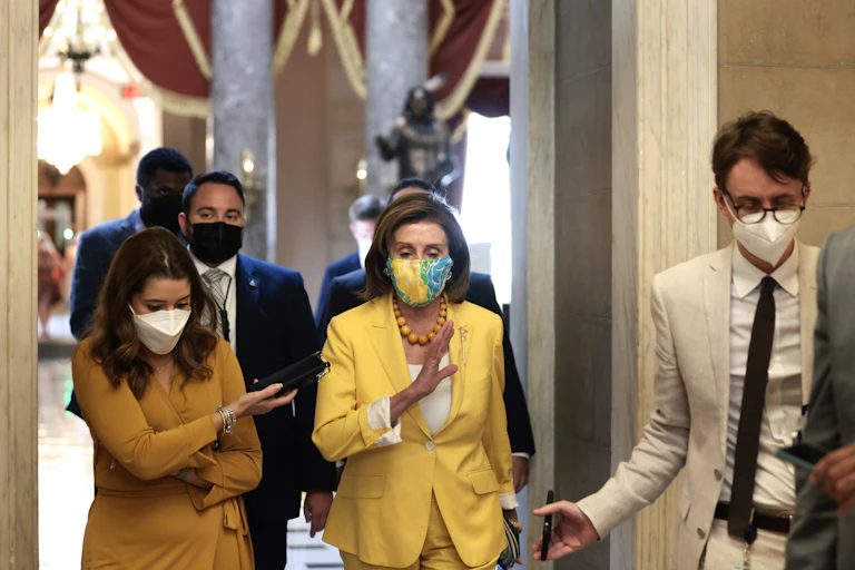 House Speaker Nancy Pelosi speaks to a reporter as she walks her office at the U.S. Capitol on August 24, 2021 in Washington, DC