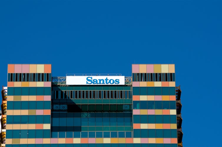 The top of the Santos building in front of a sunny blue sky