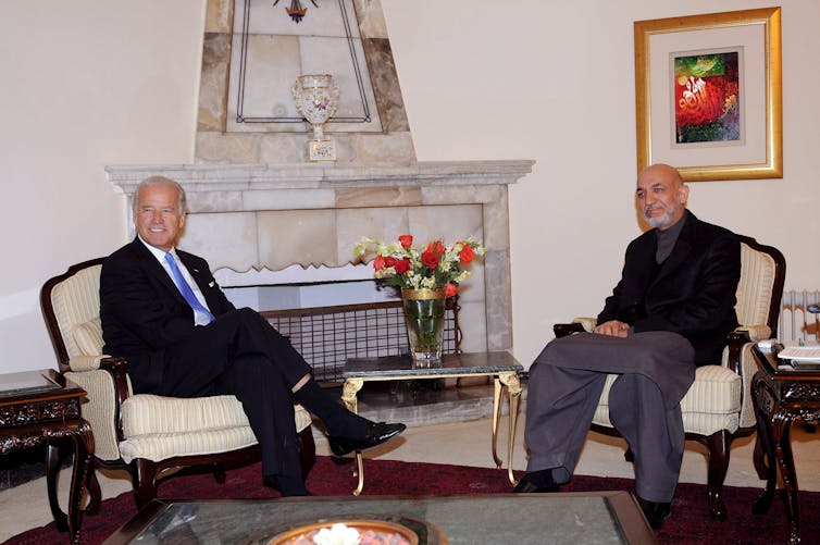 US president Joe Biden sits with the then Afghan president Hamid Karzai in a meeting room in Kabul, January 2009.